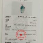 A jewelry testing certificate for the Jadeite Leaf Pendant features its photo, details such as total mass (7.451g), color (light green, greenish white), and a red authenticity stamp.