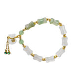 The Icy Green Tianshan Cui Chalcedony Bracelet features irregular white and green bamboo-knot beads, gold spacers, a gold adjustable chain, and a white lucky pouch charm at the clasp.