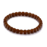 Studio photo of a cognac-brown Nephrite (soft jade) bracelet, featuring drum-shaped beads with a high-polish finish, on a white background.