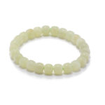 Studio photo of a pale cream Nephrite (soft jade) bracelet, featuring drum-shaped beads with a soft-gloss polish, on a white background.