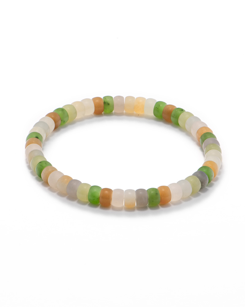 LYU_3819 Pastel spectrum nephrite jade heishi bracelet in white, gray, green, and warm tan tones, photographed on a clean white background.