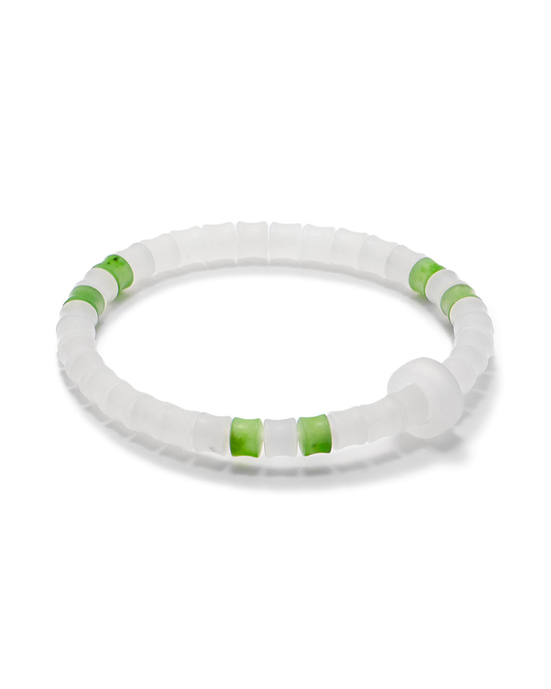 LYU_3820 Studio photo of a mist-white Nephrite (soft jade) bracelet, featuring carved disc beads with vivid green accent beads, on a white background.