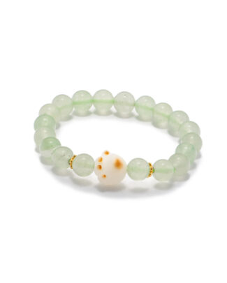 Studio photo of a light green Quartzite jade bracelet, featuring spherical beads with a spotted white center accent and subtle gold-tone spacers, on a white background.