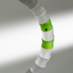 A close-up of the Natural White Nephrite Jade Bracelet, featuring handmade translucent beads with alternating white and two green segments, set against a soft gray and white gradient background.