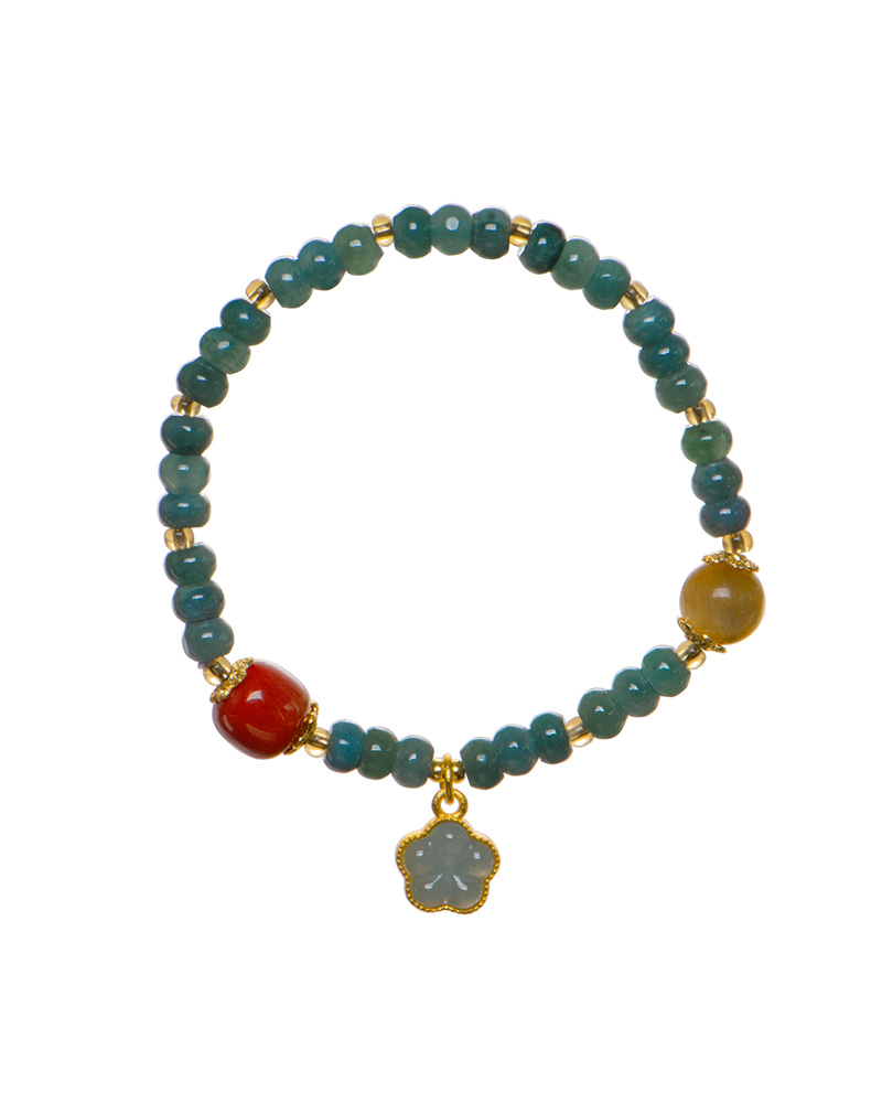 LYU_4071 The Teal Green Jadeite Bracelet features teal disc beads, a trio of charms, gold spacers, and a clover-shaped pendant with a gold outline. Displayed on a white background.