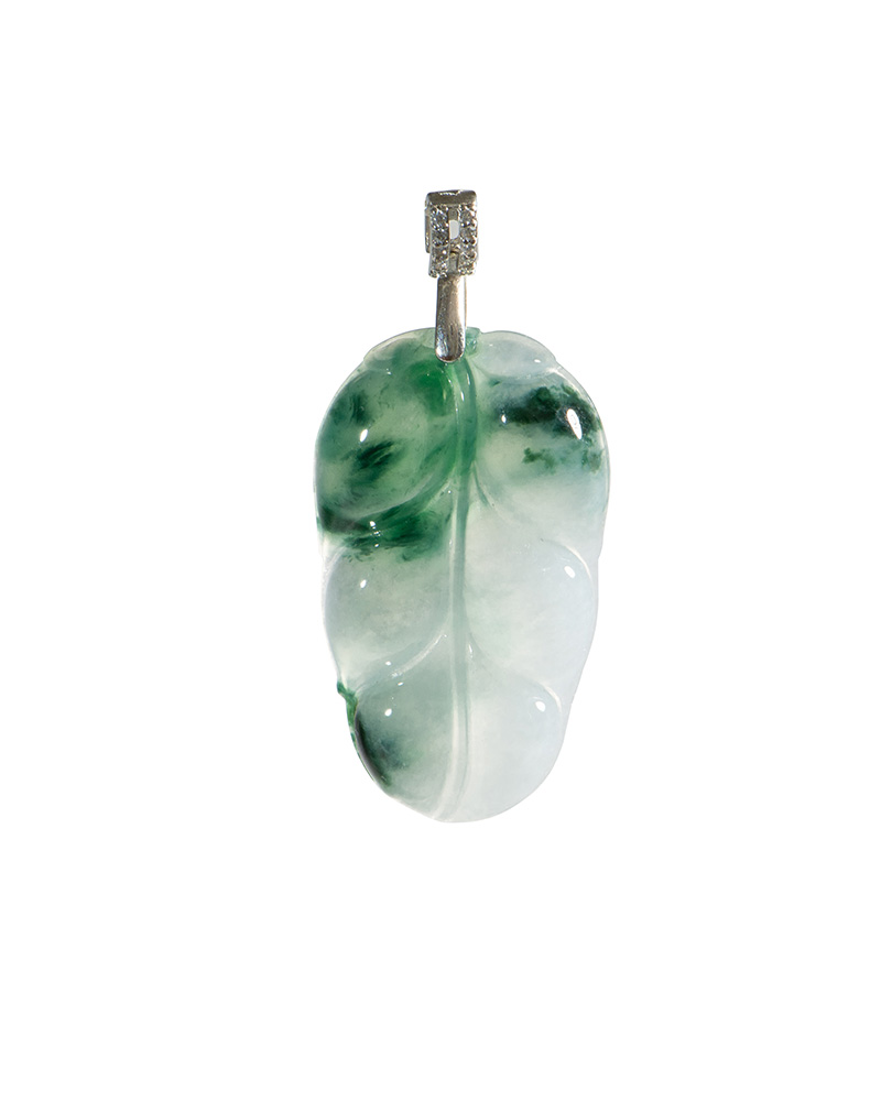 Leaf-carved jadeite pendant with misty green inclusions and a high-polish sterling silver bail, on a white background