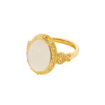 Studio photo of a white Nephrite (soft jade) ring, featuring an oval cabochon in an ornate high-polish gold-tone setting, on a white background