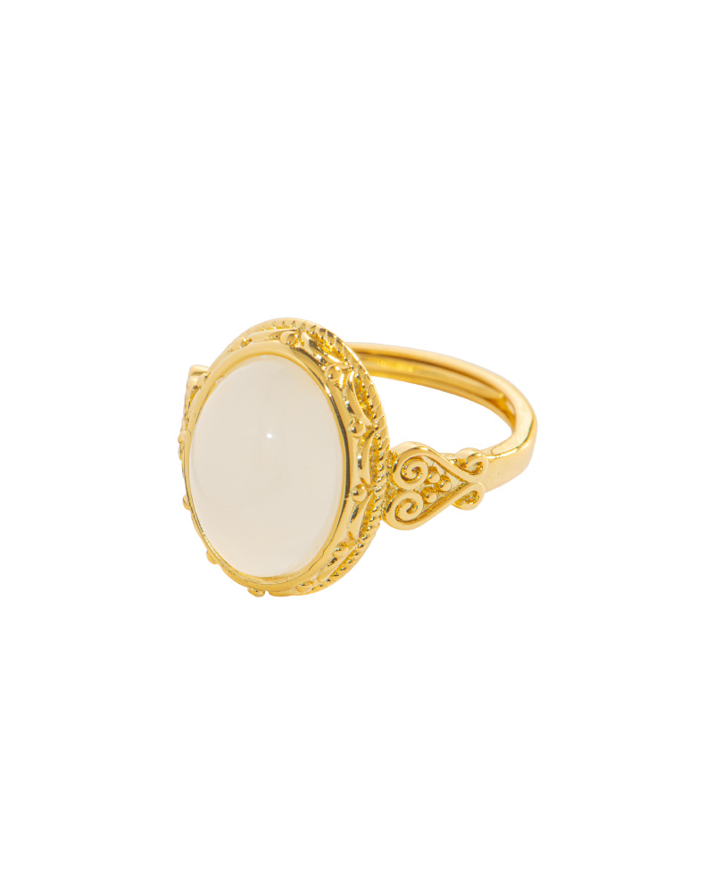 Studio photo of a white Nephrite (soft jade) ring, featuring an oval cabochon in an ornate high-polish gold-tone setting, on a white background