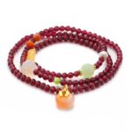 Purplish-red garnet multi-wrap bracelet with a peach-toned drop and warm gold accents on a white background.