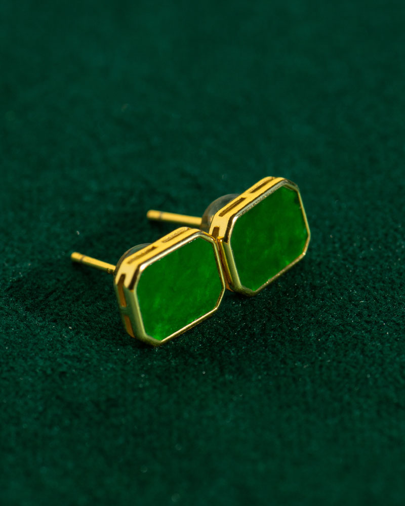 Vivid Green Jadeite Stud Earrings – rectangular flat inlay set in gold-plated 925 sterling silver, shown on a dark green textured surface.
