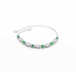 Green & greenish white jadeite halo station bracelet with oval cabochons and bezel-set brilliance in high-polish sterling silver.