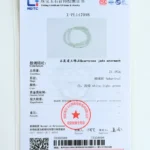 A gemstone testing certificate featuring a circular quartzose jade adornment, with detailed information in Chinese and English about the gemstones weight, shape, color, and authenticity, plus an official stamp.