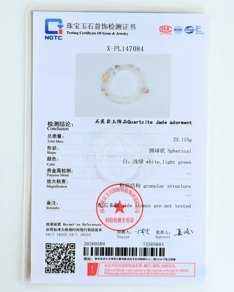 A gemstone testing certificate featuring a photo of a beaded bracelet. The document includes text details on composition, weight (23.115g), color, shape, and a red official stamp. The certificate is predominantly white with blue accents.