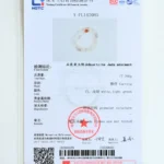 A jewelry testing certificate displays details and a photo of a carved quartzite jade adornment, including its weight, color, and structure, with official stamps and a barcode at the bottom.