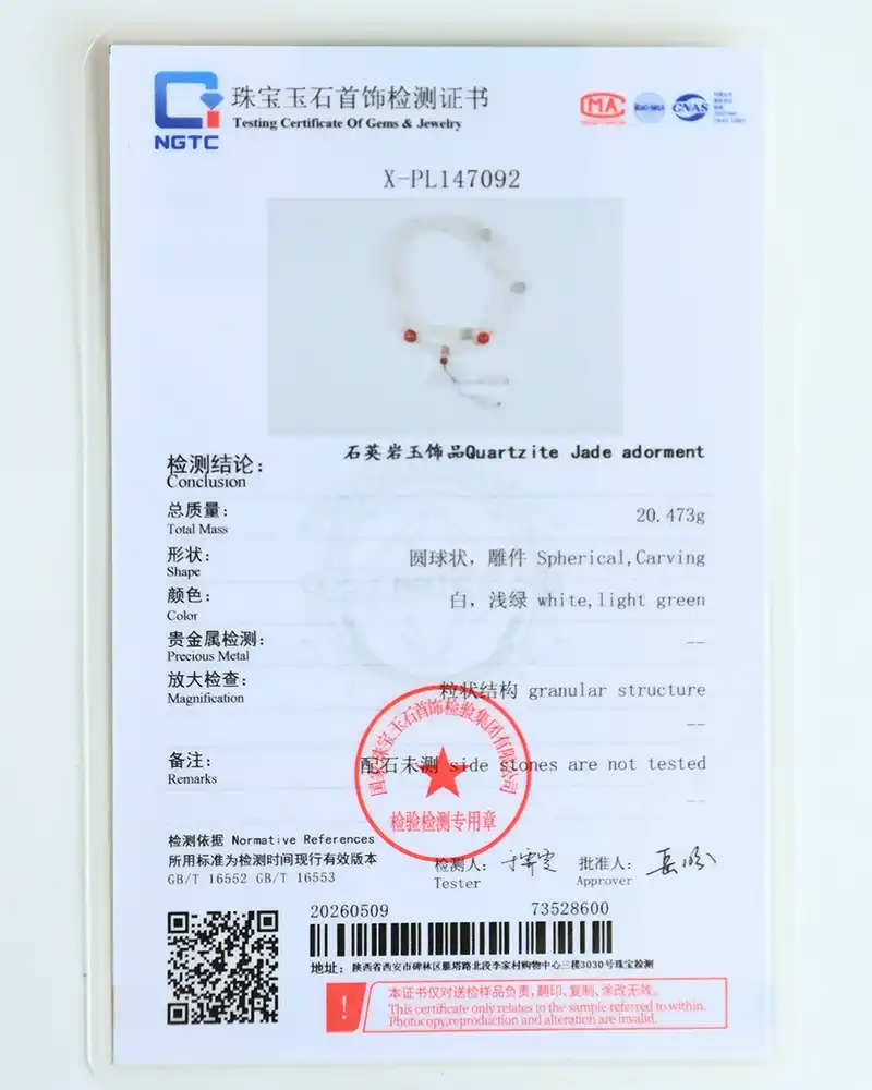 A gemstone testing certificate displays details for a Quartzite Jade adornment, including weight, shape, color, structure, and a red beaded bracelet photo. The document features official stamps and a barcode at the bottom.
