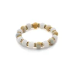 A beaded bracelet featuring alternating white and yellow round stones with small gold and rhinestone spacer beads between each stone, arranged in a circular pattern.