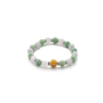 light green, greenish white, brownish yellow jadeite bracelet showing spherical beaded bracelet with a compact elastic silhouette