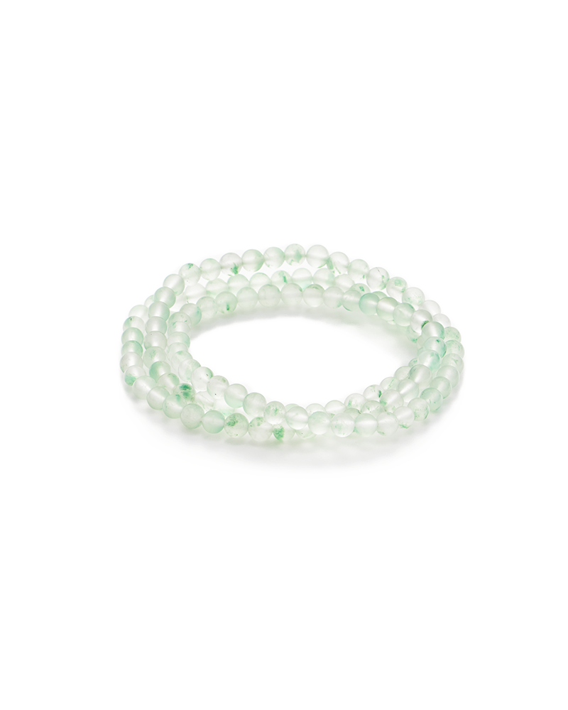 A coiled bracelet made of translucent, light green round beads, arranged in multiple loops, displayed on a plain white background.