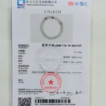 A jewelry testing certificate featuring a photo of a light green jadeite beaded bracelet. The certificate includes text in Chinese and English, a red stamp, a barcode, and official signatures.