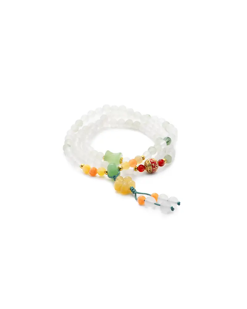 white, light green quartzite jade bracelet showing beaded bracelet with carved accent details and a small pendant drop