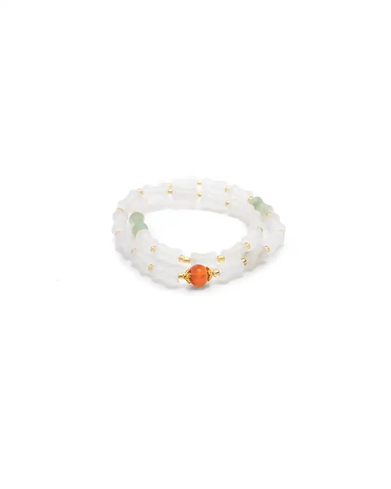 LYU_4883 white, light green quartzite jade bracelet showing carved bead adornment with link-like white forms and a red focal accent