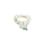 white, light green quartzite jade bracelet showing beaded bracelet with a carved donut pendant and small green drop accents