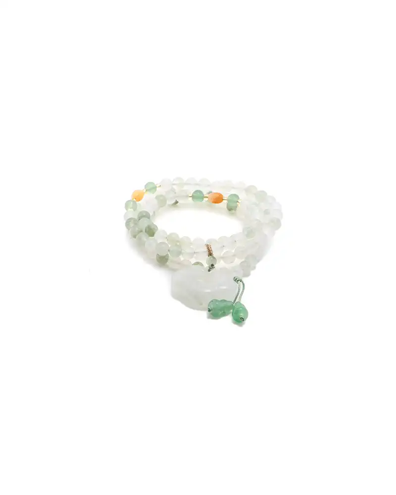 white, light green quartzite jade bracelet showing beaded bracelet with a carved donut pendant and small green drop accents