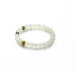 Light green Jadeite bracelet with spherical beads detail on white background