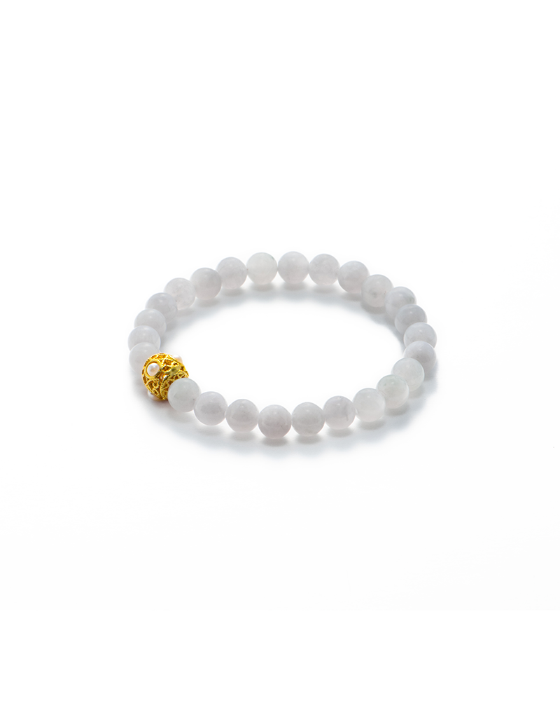 A beaded bracelet made of round, white stones with a single decorative gold bead, displayed on a white background.