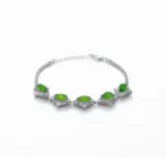 Green Nephrite Jade bracelet with marquise cabochon detail on white background