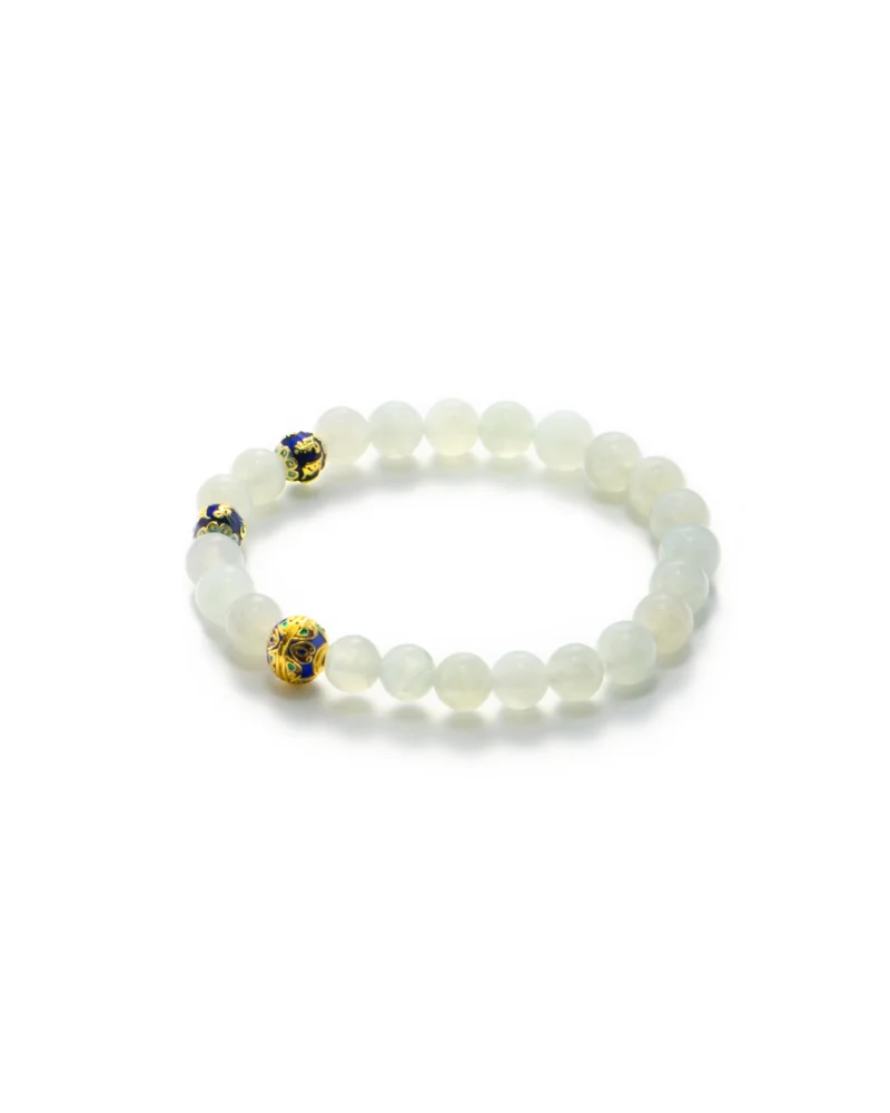 Light Green Jadeite Bead Bracelet — Spherical beads of translucent white jadeite are complemented by three distinctive yellow and black patterned accent beads, arranged on a white background.