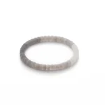 A simple, round bracelet made of smooth, light gray beads is displayed on a white background.