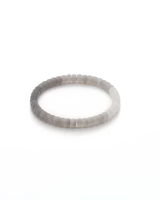 A simple, round bracelet made of smooth, light gray beads is displayed on a white background.
