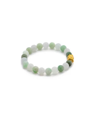 A beaded bracelet made of round, light green and white jade stones, featuring one gold bead with intricate detailing, arranged in a circle on a white background.