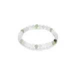 A beaded bracelet made of alternating white and light green round beads, featuring a small gold accent bead with a black design. The bracelet is arranged in a circular shape on a white background.