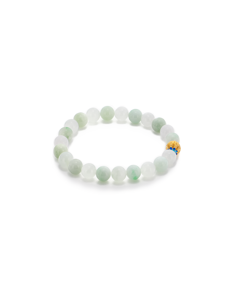 A beaded bracelet made of round, pale green jade beads with one distinctive gold bead featuring blue and red accents, arranged in a circle on a white background.