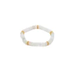 A beaded bracelet made of translucent white stones with four gold accent spacers evenly placed around it, displayed on a white background.