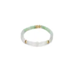 A delicate beaded bracelet featuring light green, white, and gold beads arranged in a simple, elegant pattern on a stretchy band, displayed on a white background.
