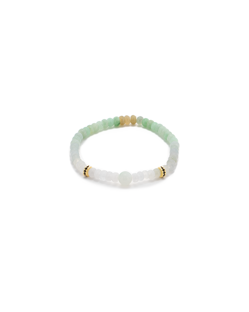 A delicate beaded bracelet featuring light green, white, and gold beads arranged in a simple, elegant pattern on a stretchy band, displayed on a white background.