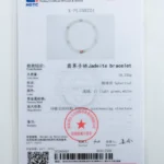 A gemstone testing certificate displays details of a jadeite bracelet, including its weight, shape, color, and internal structure, with a QR code and official stamps at the bottom.