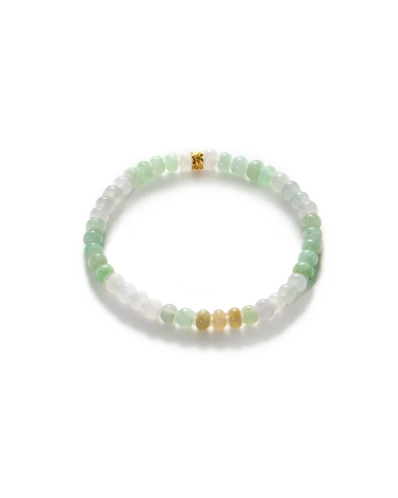 The Brownish-Yellow, Light Green and White Jadeite Bracelet features ring-shaped beads arranged in a repeating pattern, accented with gold-tone details. Displayed on a white background, this bracelet showcases the beauty of multicolored jadeite in brownish-yellow, light green, and white hues.